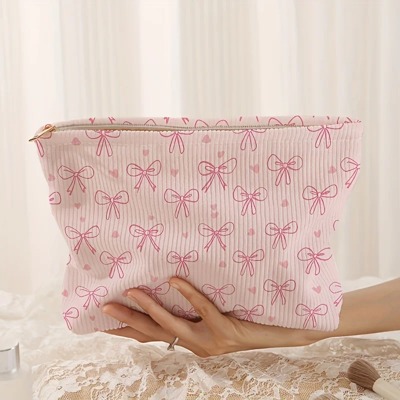 Trousse de maquillage à fermeture éclair en velours côtelé imprimé à motif de nœud rose de conception minimalement, sac de rangement de cosmétiques léger et multifonctionnel